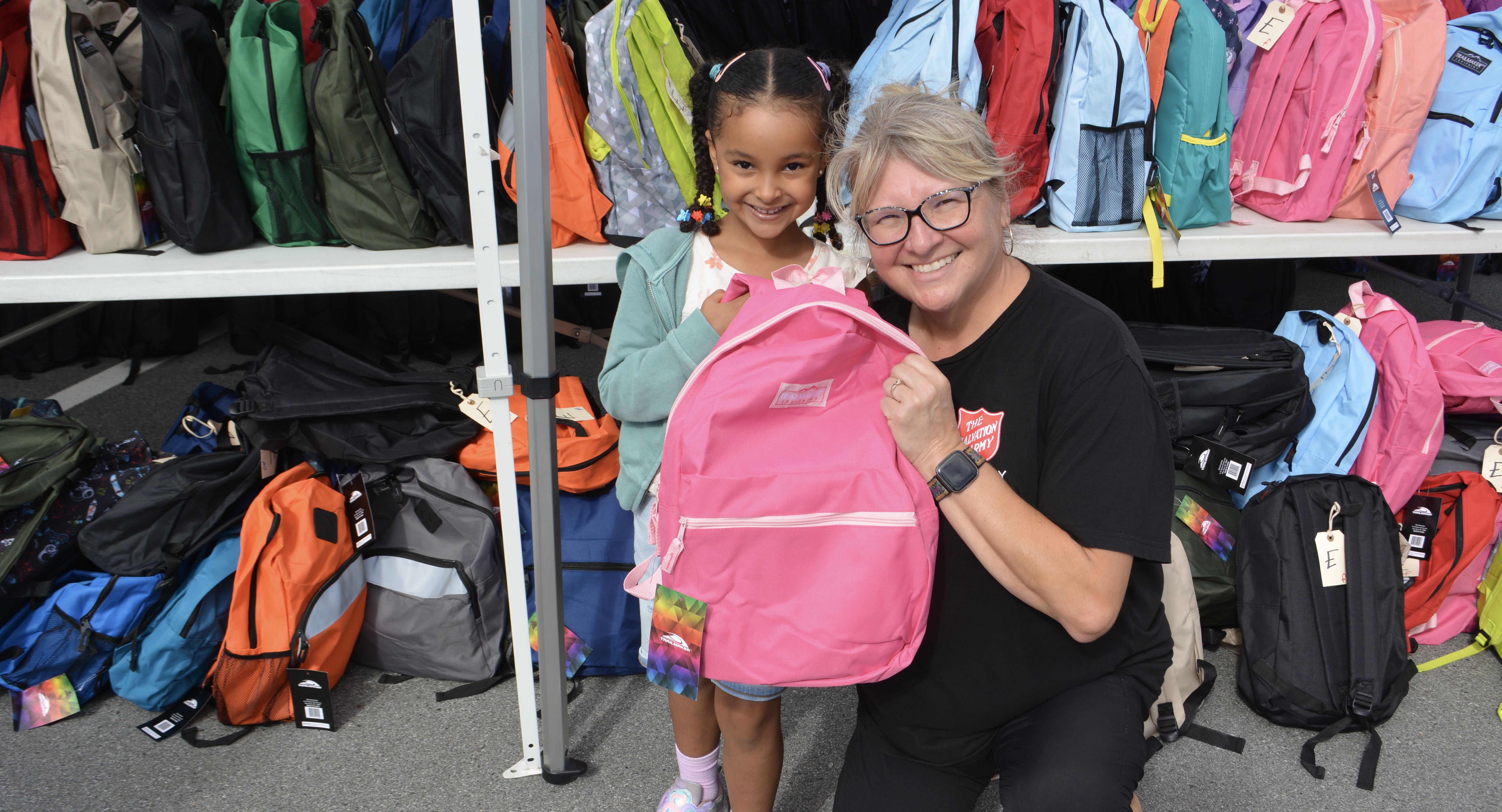 Salvation Army worker distributes backpacks